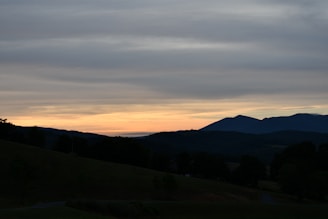 A serene landscape at dusk with soft, fading light.