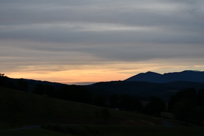 A serene landscape at dusk with soft, fading light.