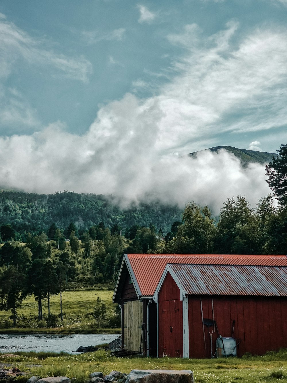 a barn with a fire in the background