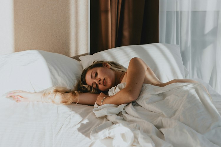 Person checking a sleep tracking app on a smartwatch after waking up