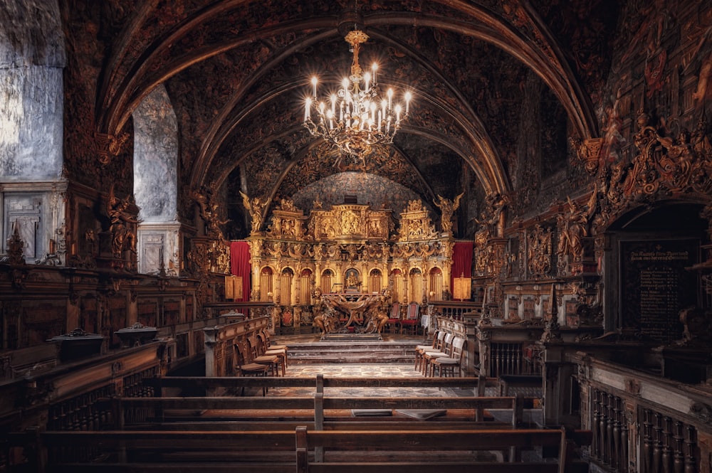 a large ornate church with a chandelier and pews