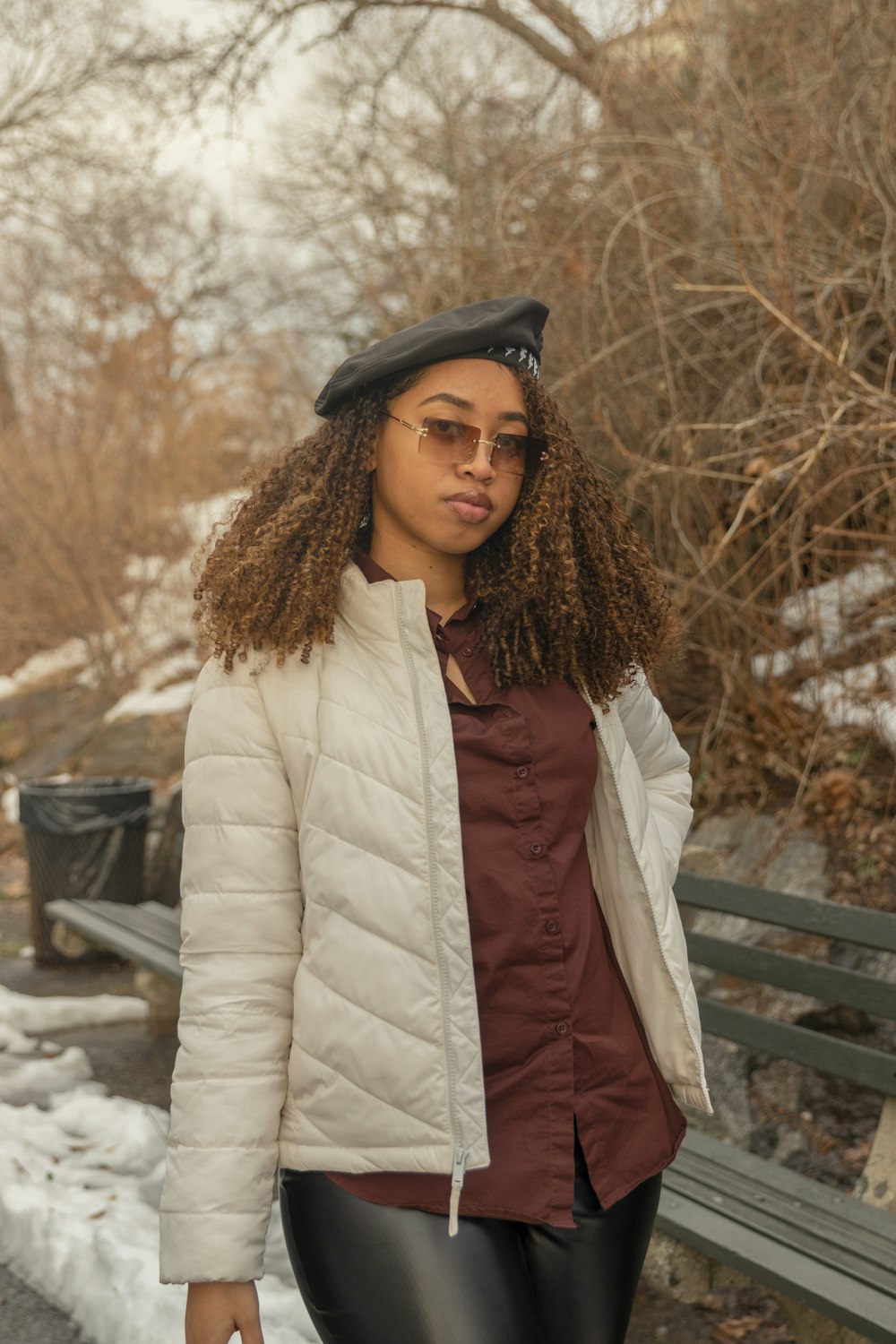 a woman wearing a hat and glasses