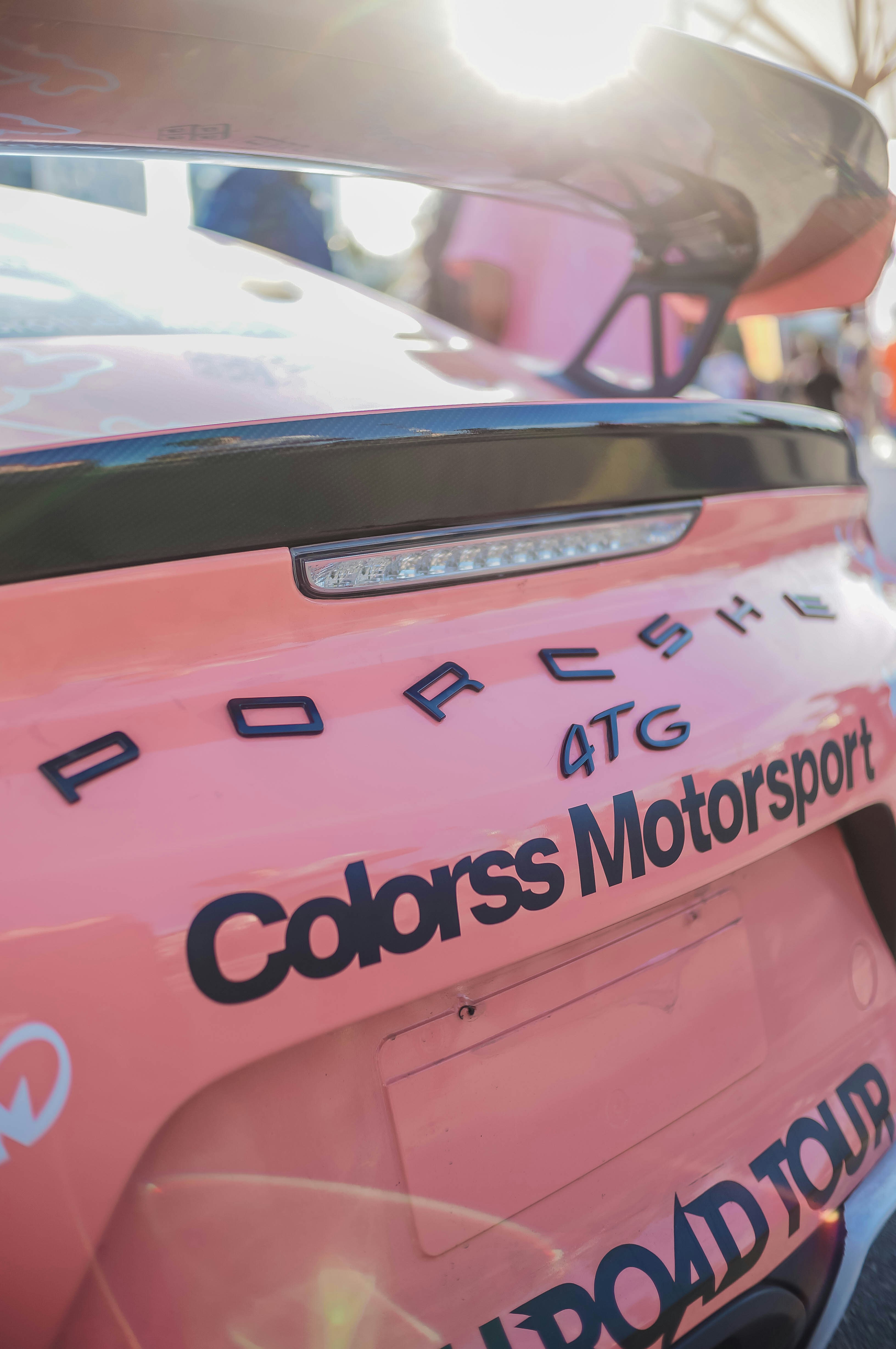 a pink car with a white and blue logo