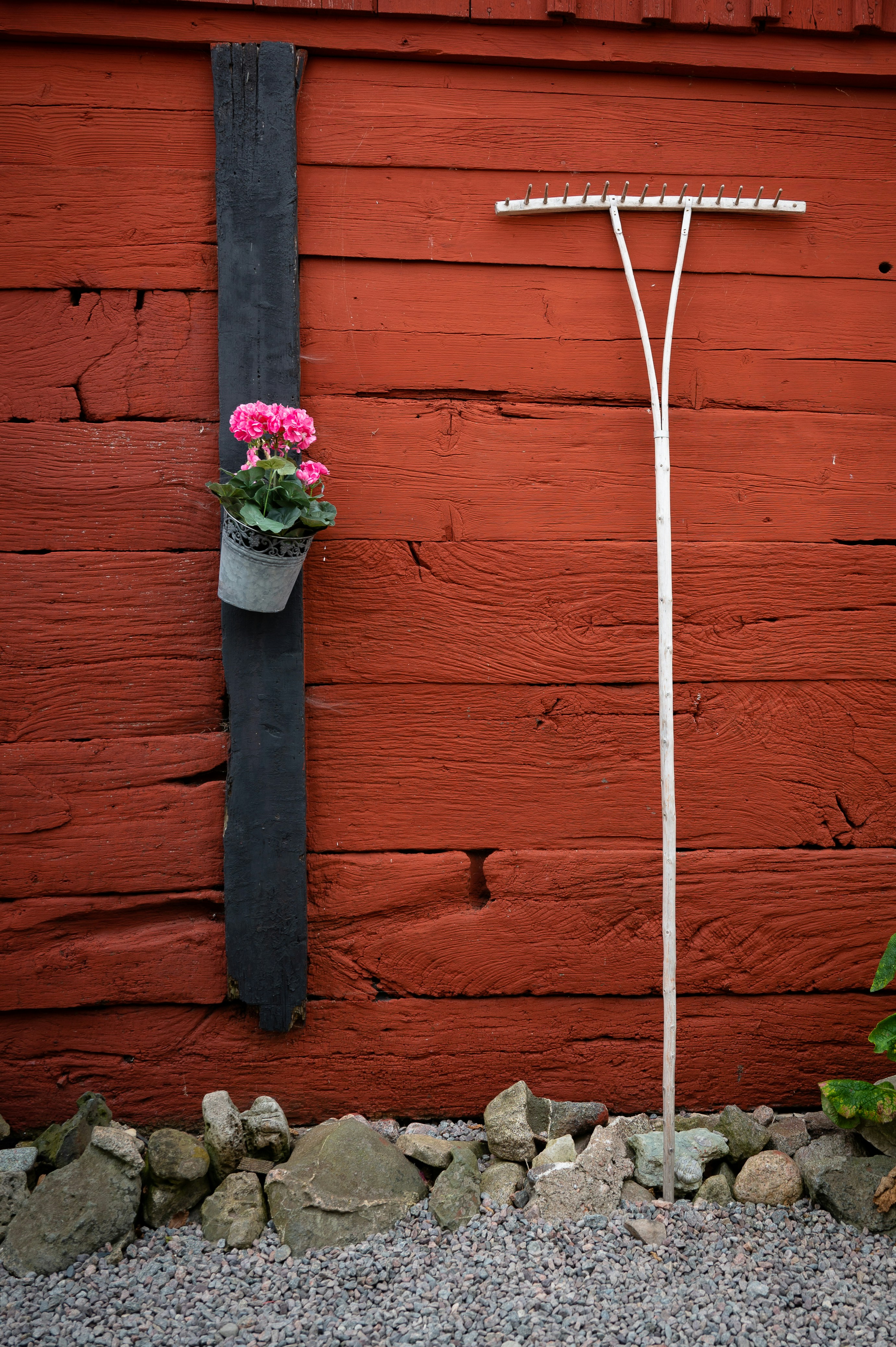 a planter with flowers on a pole
