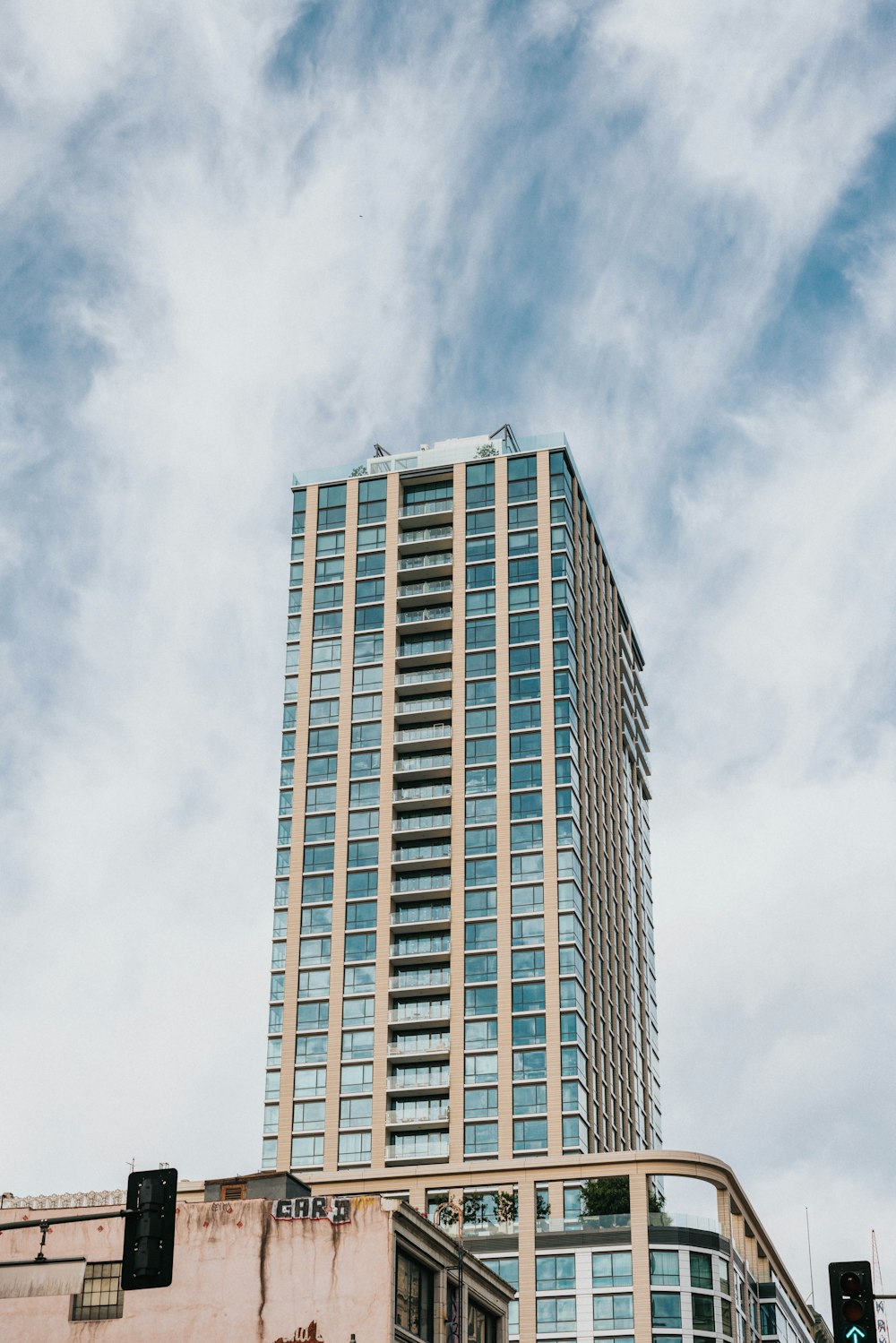 Un edificio alto con un cielo nuvoloso