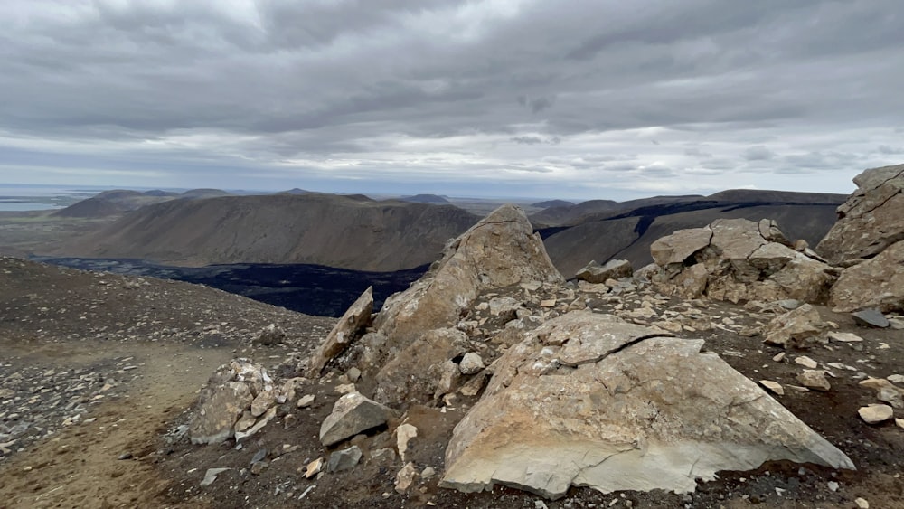 a rocky landscape with mountains in the background