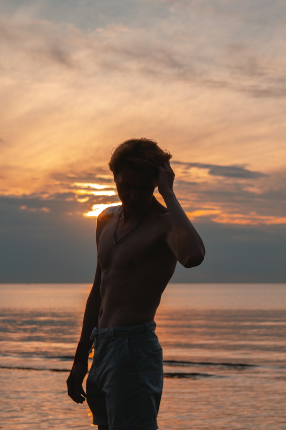 a man standing next to a body of water