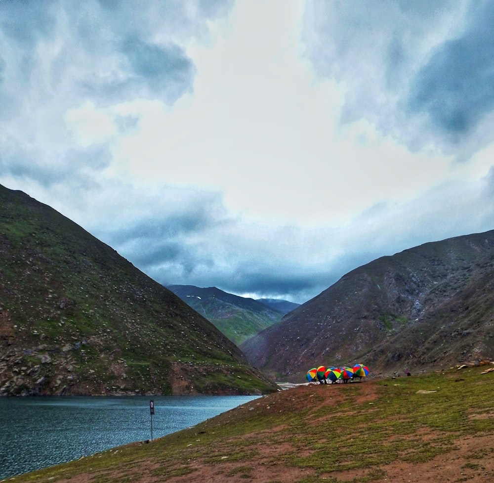 a group of people on a trail by a lake