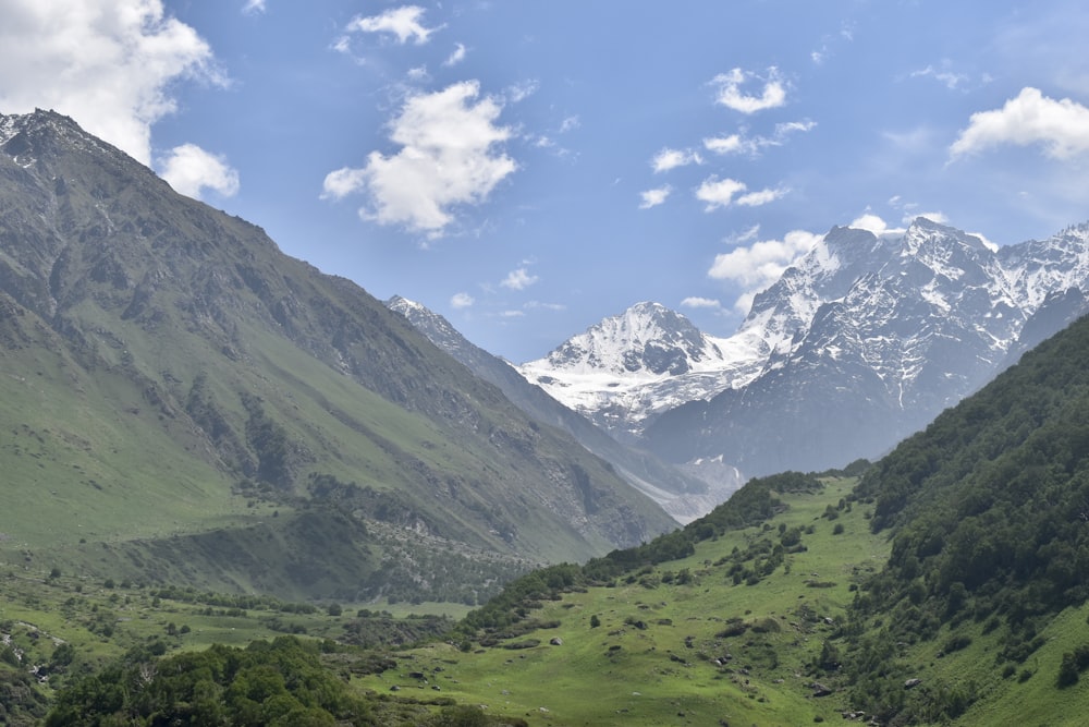 a valley between mountains with snow