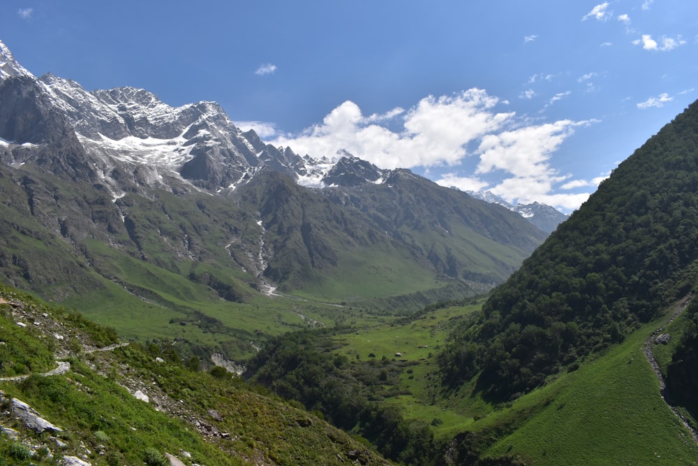 a valley between mountains with snow