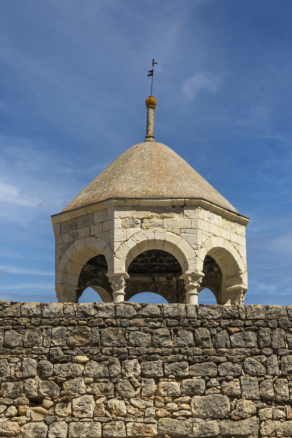 a stone wall with a domed building