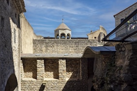 a stone wall with a building on top