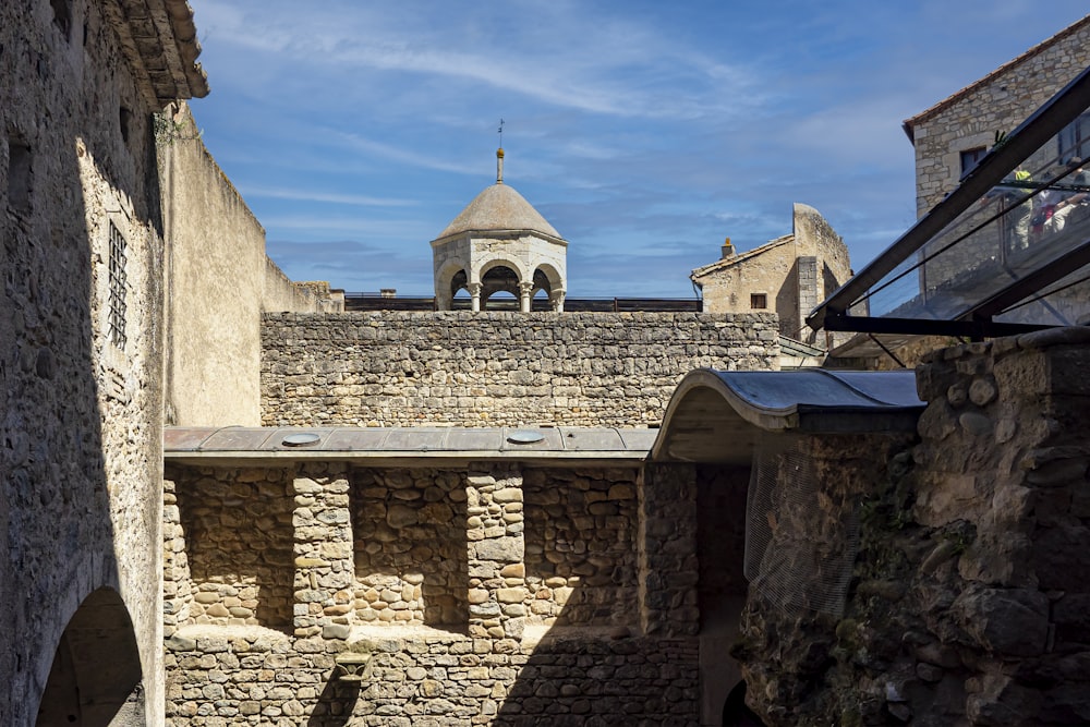 a stone wall with a building on top