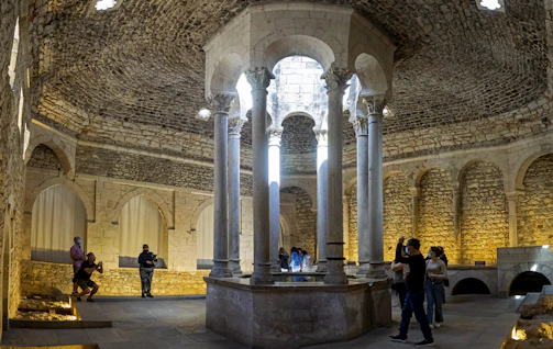 A smiling guide sharing stories with visitors inside a centuries-old cathedral.