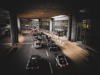 A line of limousines waiting outside a busy New York City hotel in the early morning.