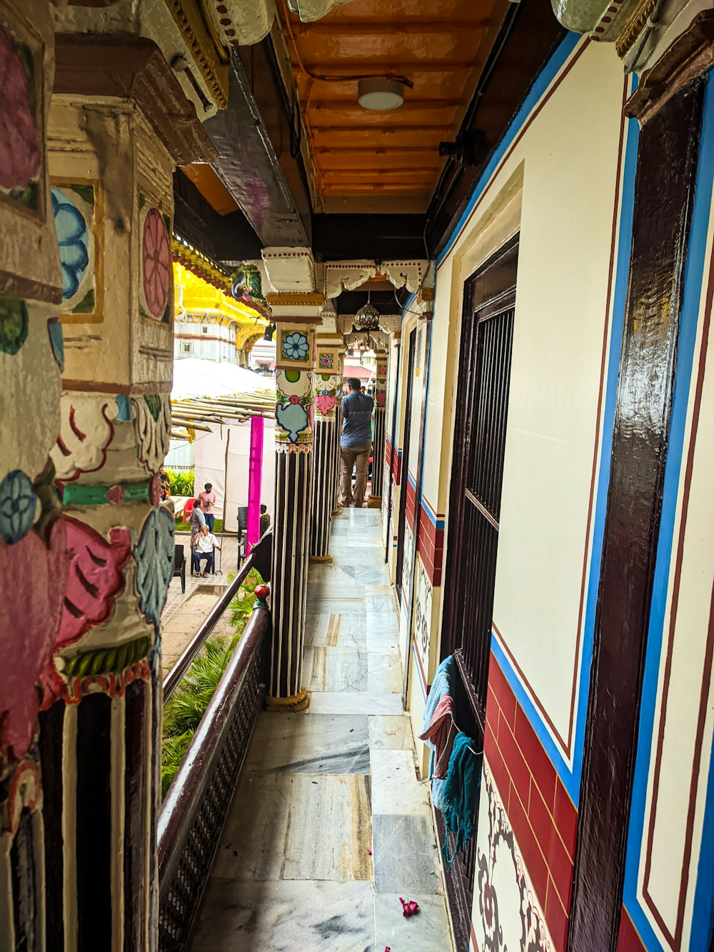 people walking down a narrow alley