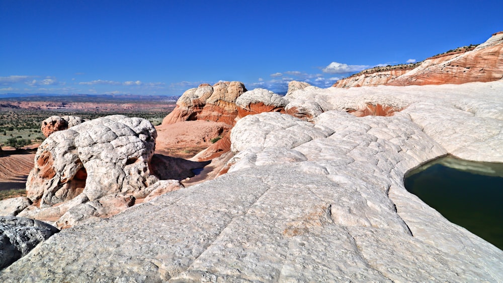 a large rock formation by a body of water