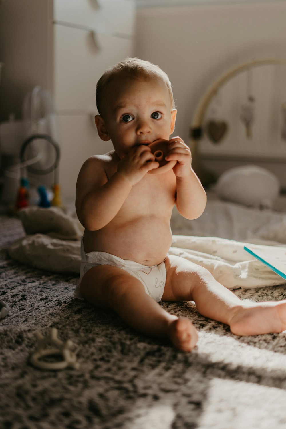 a baby sitting on the floor