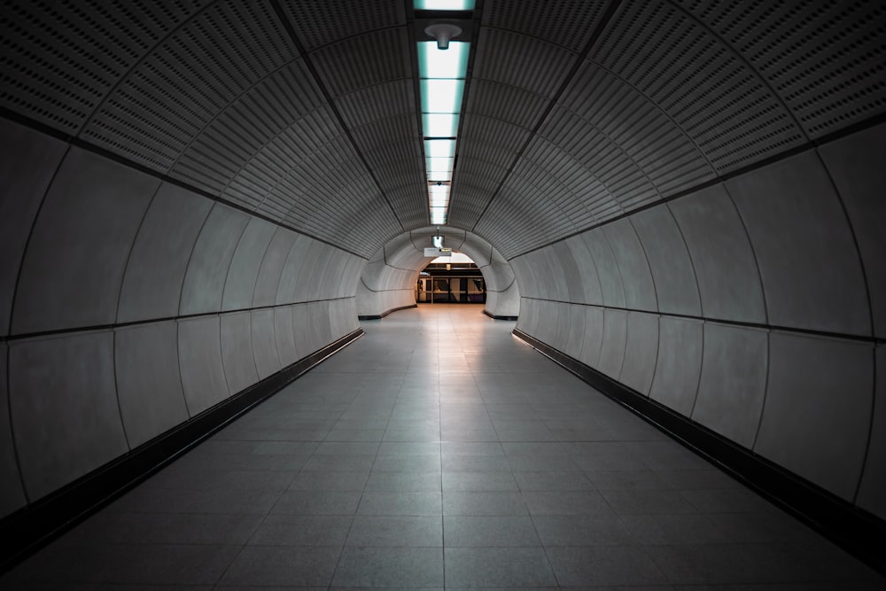 a long hallway with a light on the end