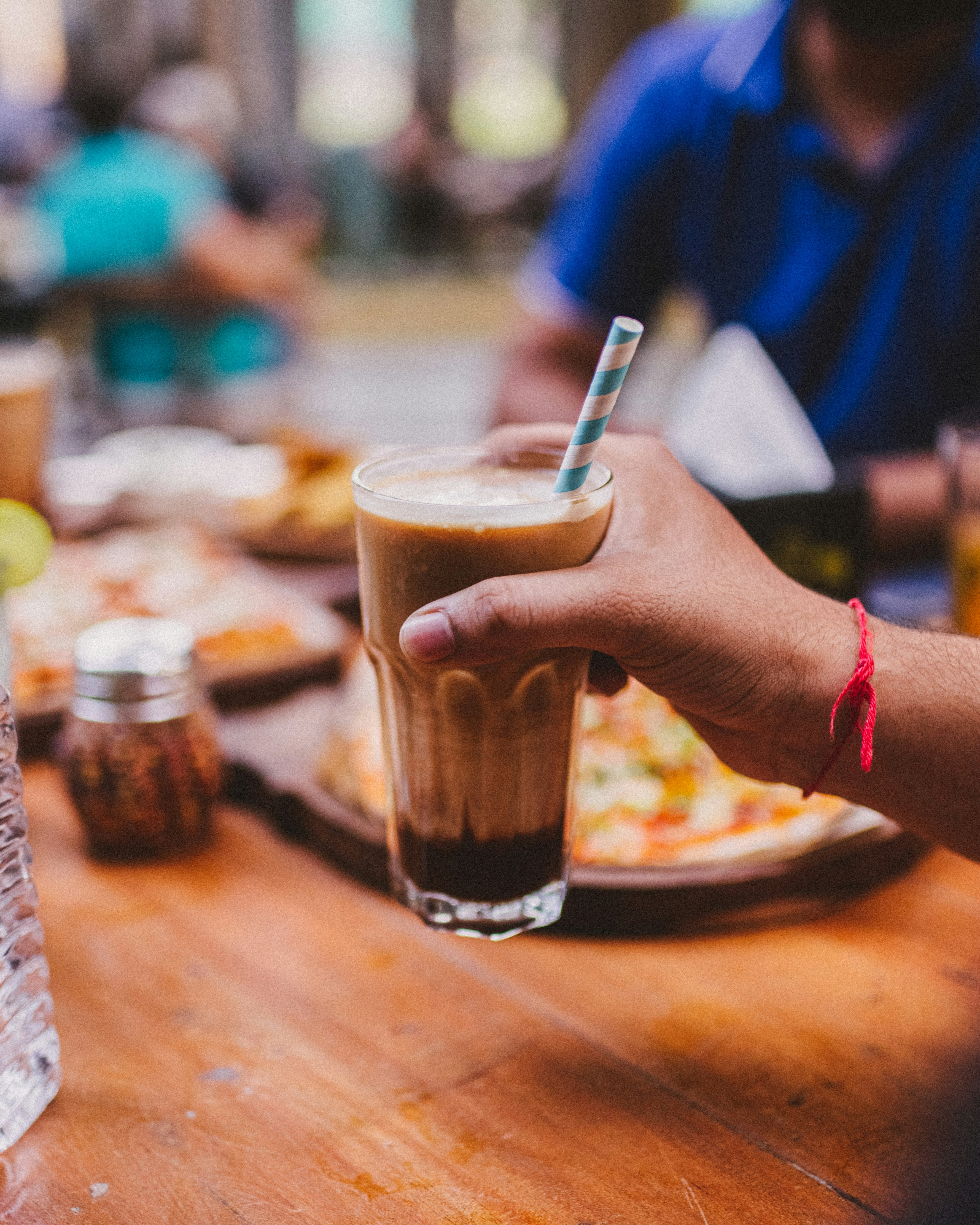 a person holding a glass of beer