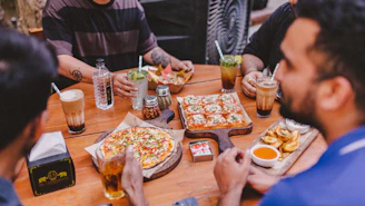 people eating pizza at a table
