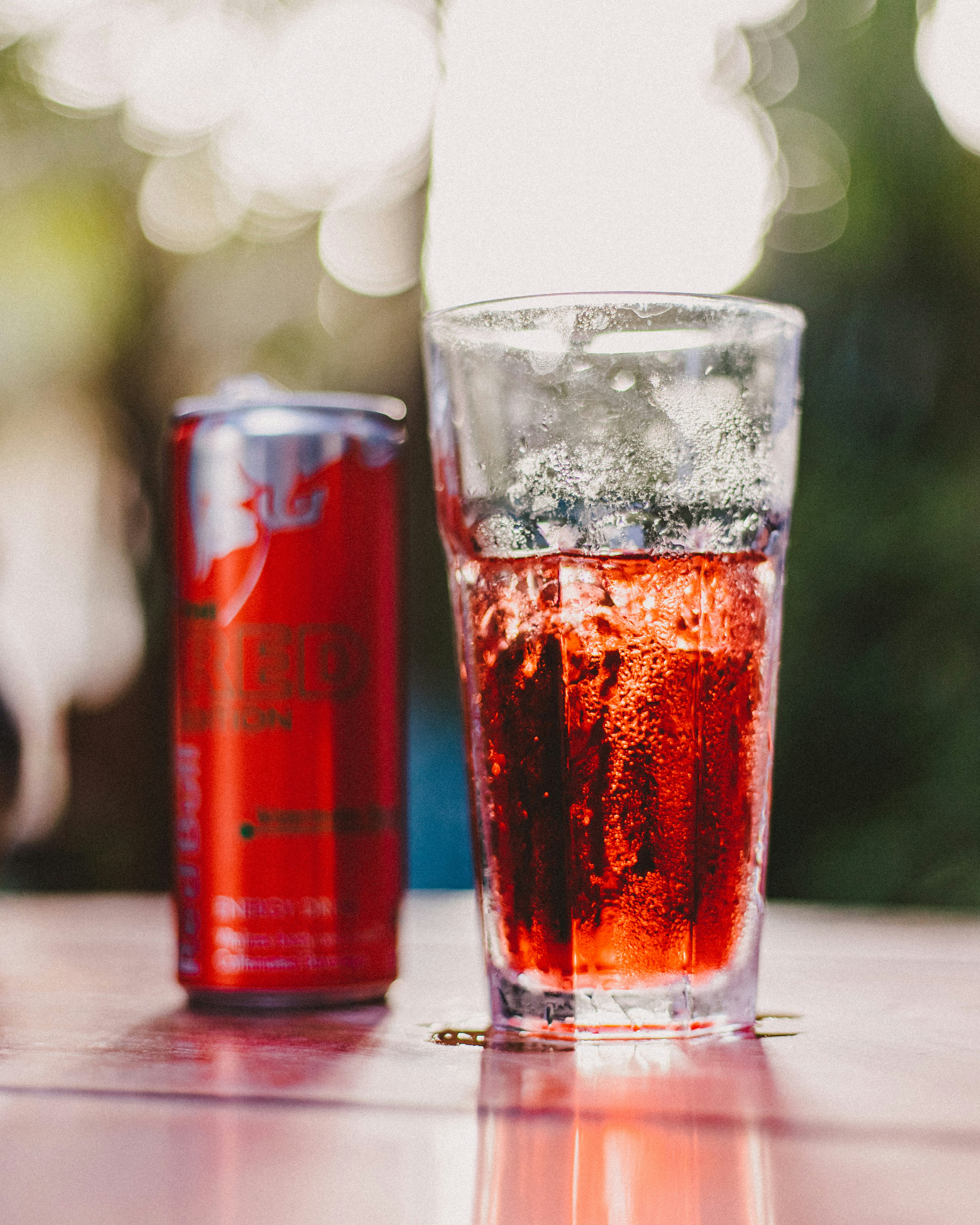 a glass of beer and a can of beer on a table