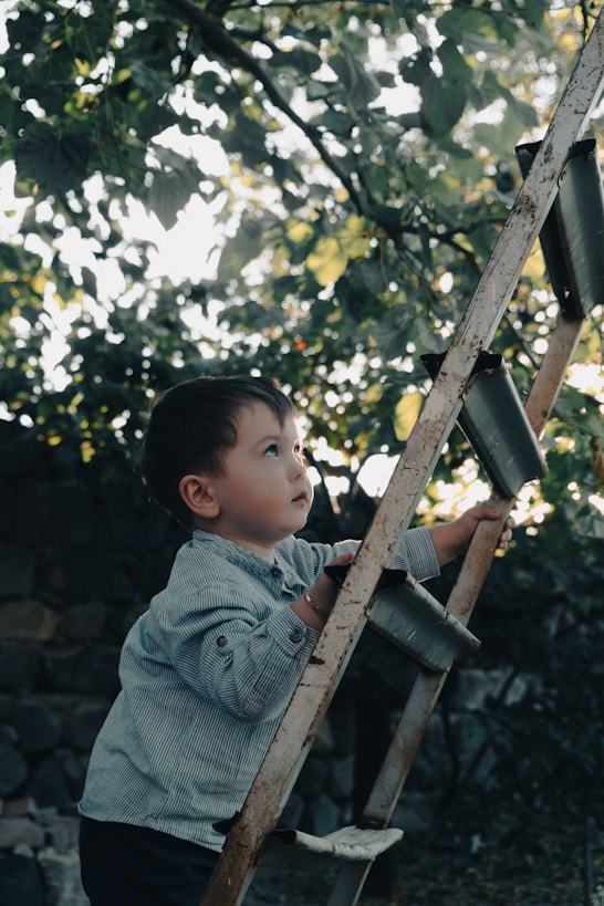 a young boy playing on a swing