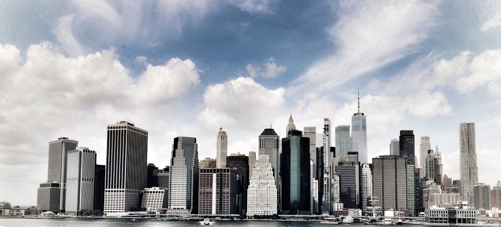 a city skyline with clouds in the sky