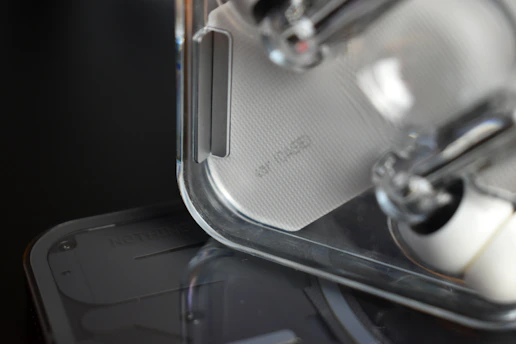 Close-up of a sleek, minimalist 3D printed product prototype on a wooden surface.