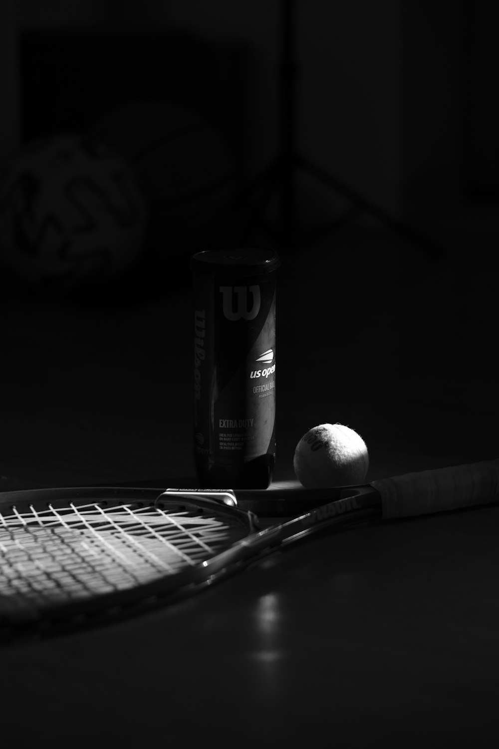 a tennis ball and a tennis racket on a table