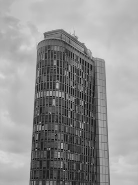a tall building with a cloudy sky