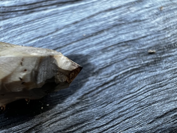Close-up of a vibrant, hand-selected mineral specimen resting on a natural wooden surface.