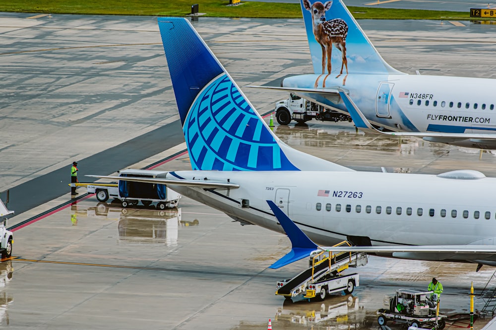 a couple of large airplanes at an airport