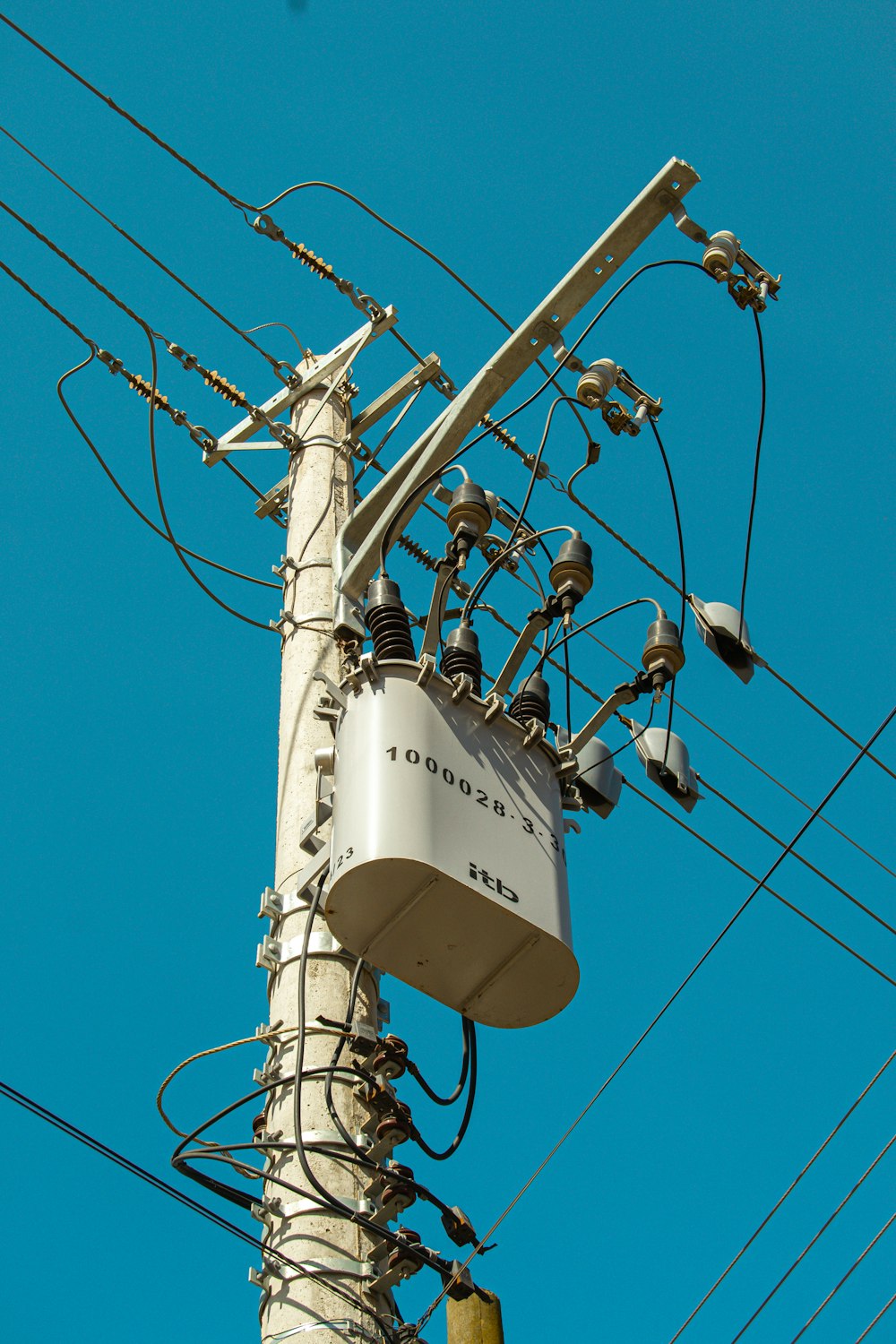 a white tower with many wires