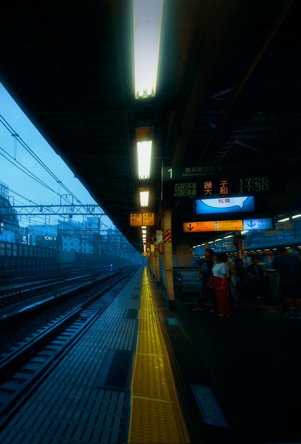 a train station with people waiting