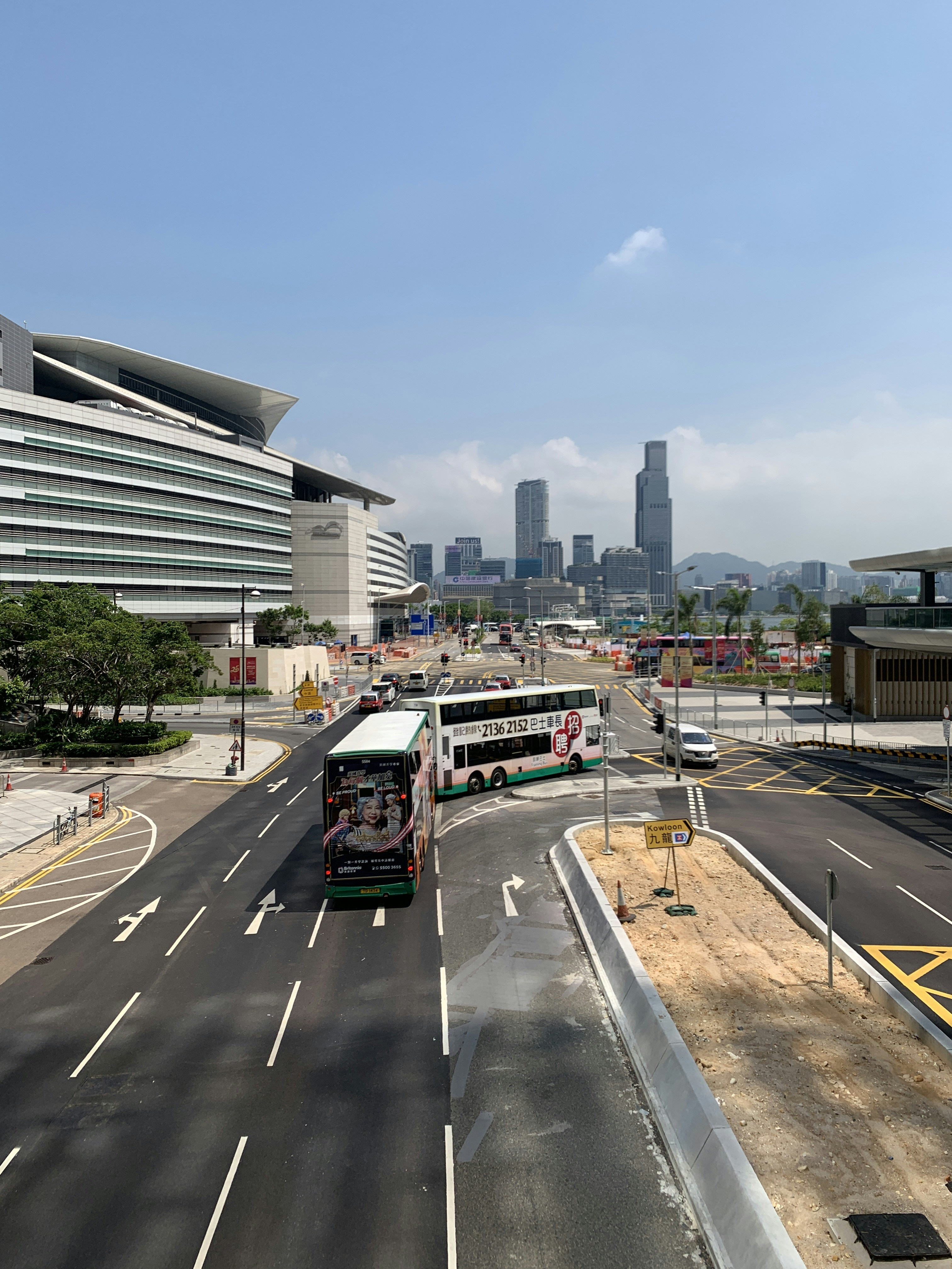Modern white and green passenger bus on city road, clear sky, urban environment