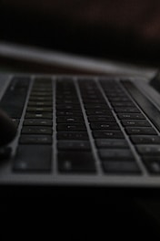Close-up of hands typing a password on a sleek keyboard.
