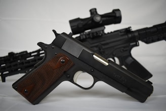 a black gun with a brown handle