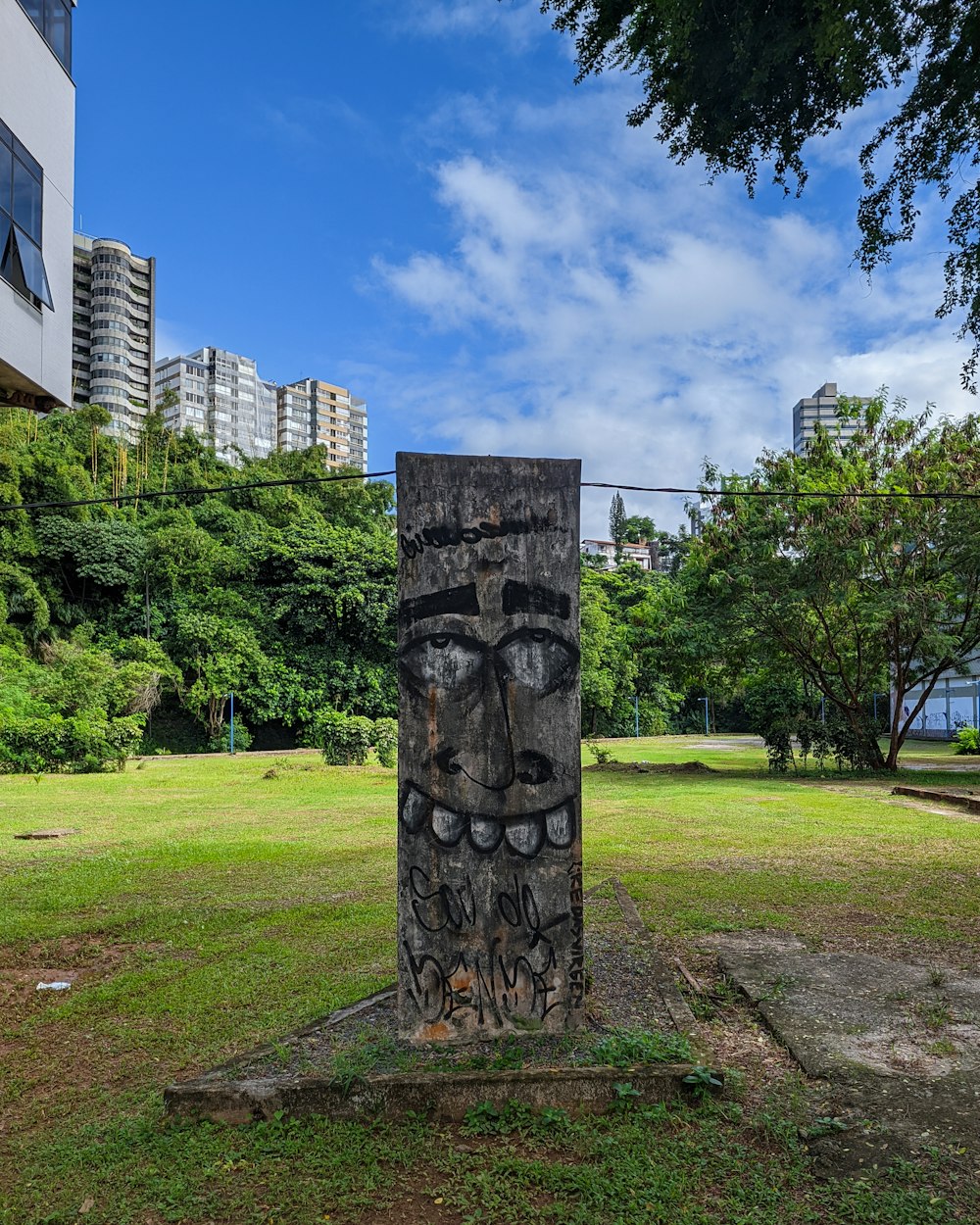 a stone pillar in a park