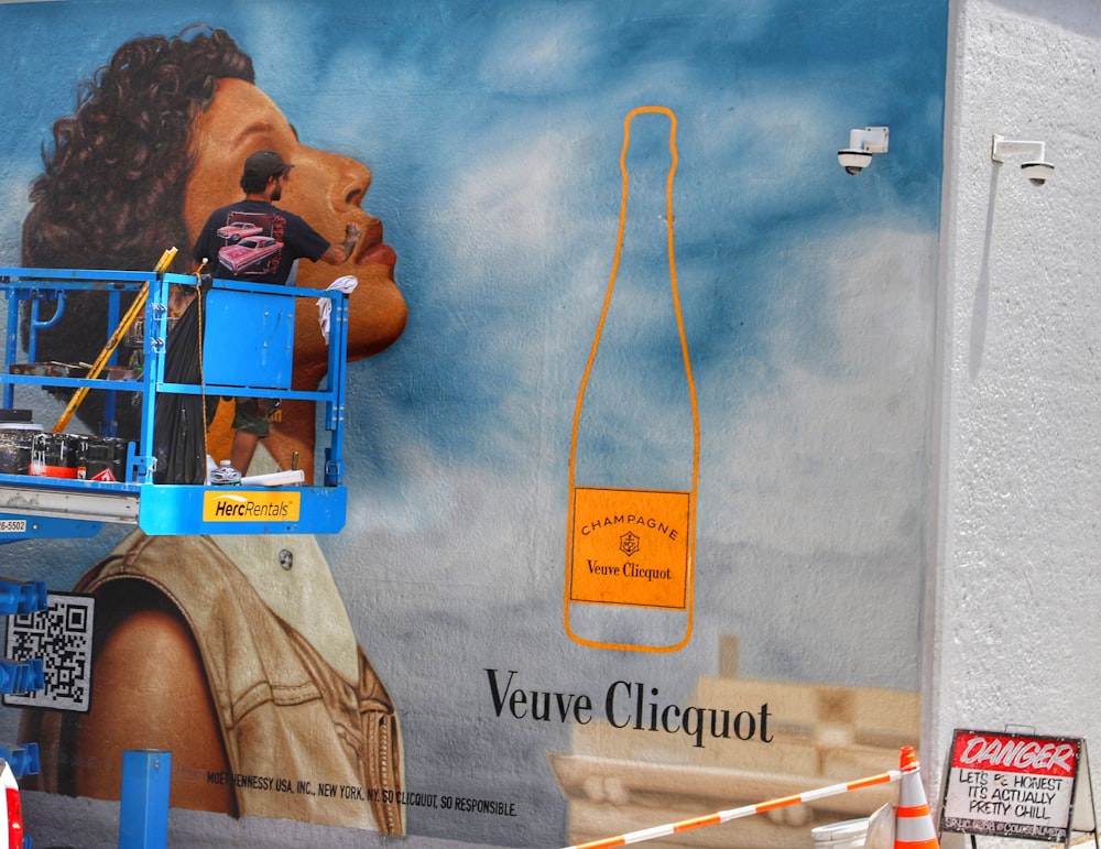 a person on a ladder painting a wall