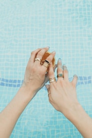 a pair of hands with wedding rings