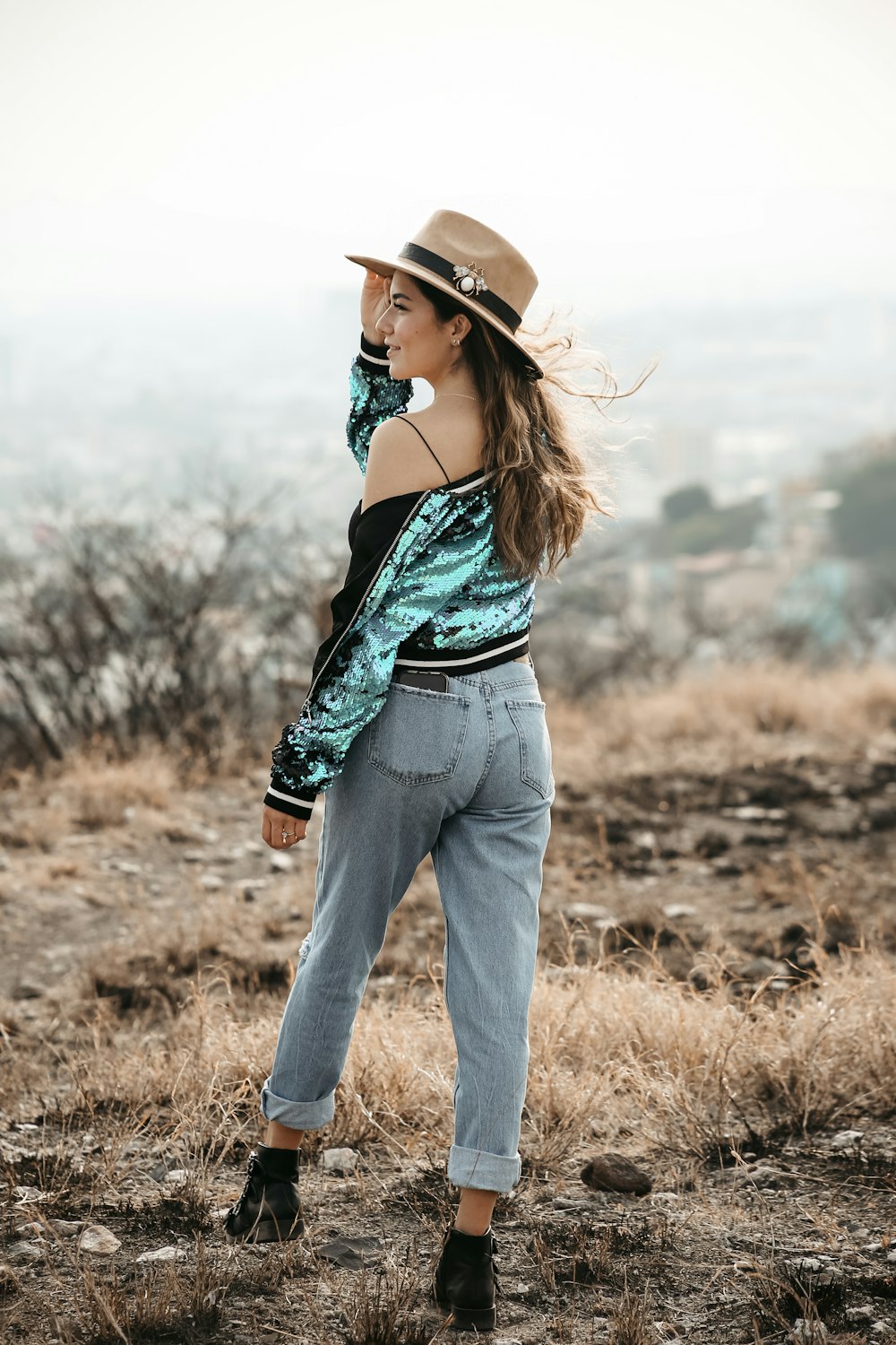 a person wearing a hat and standing outside