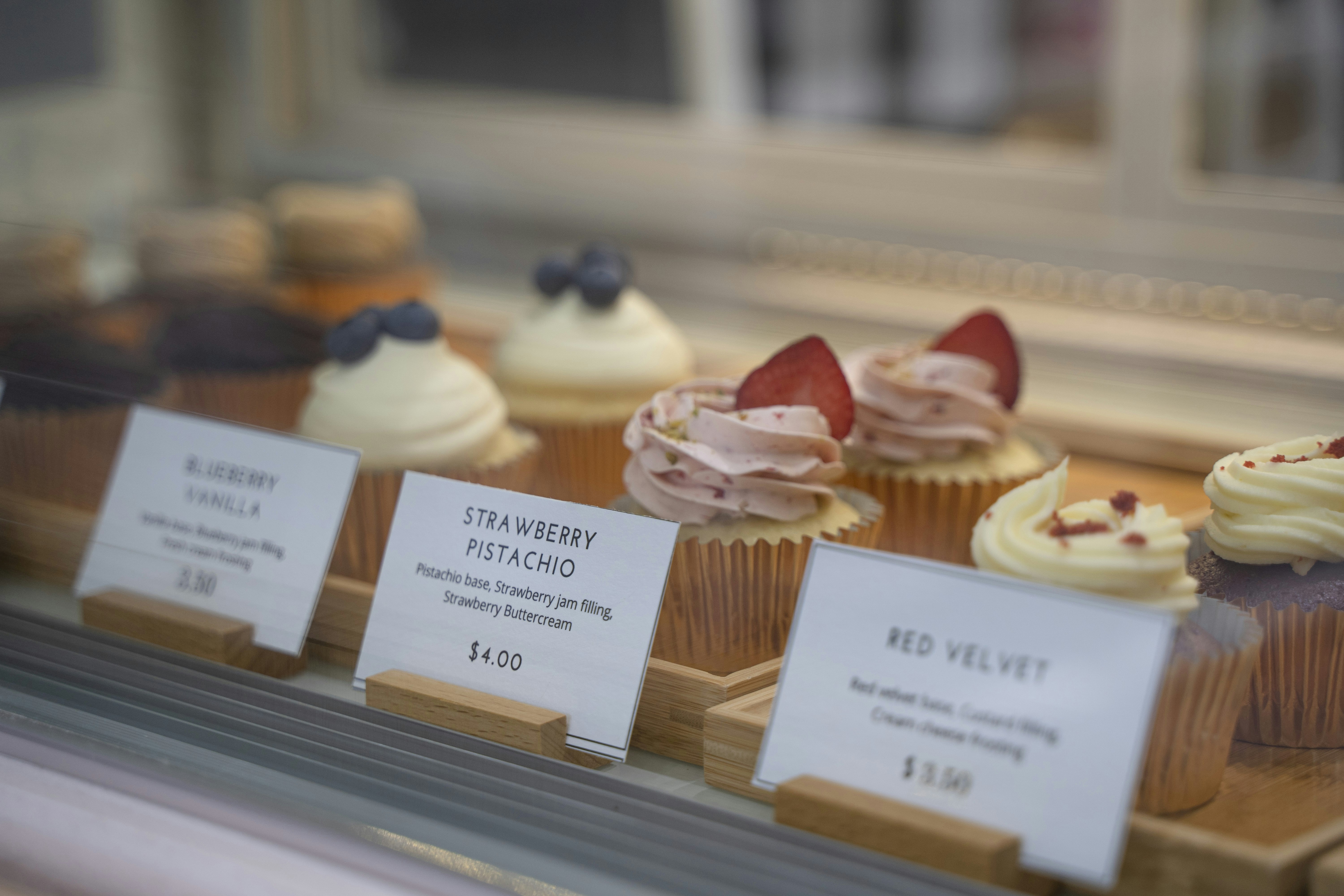 a group of cupcakes with white frosting and red and blue toppings