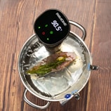 A solar-powered digital thermometer clipped onto a freshly grilled thick steak.