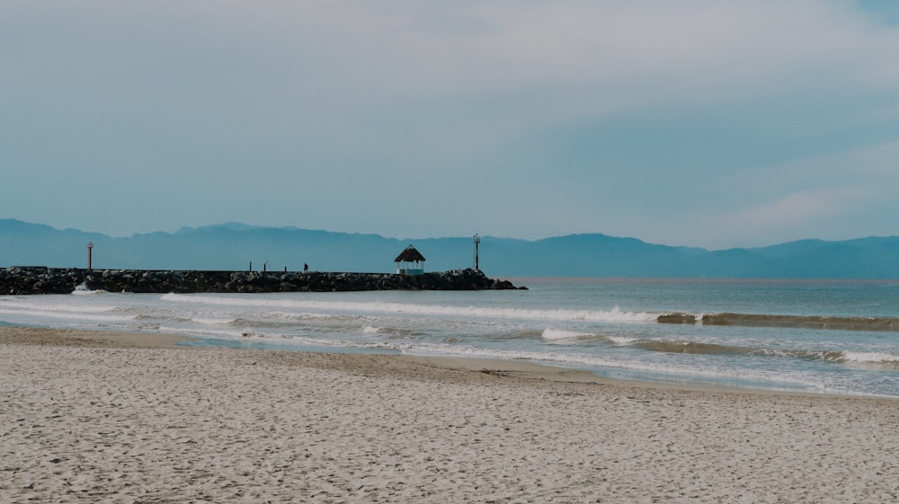 a beach with a small island in the distance