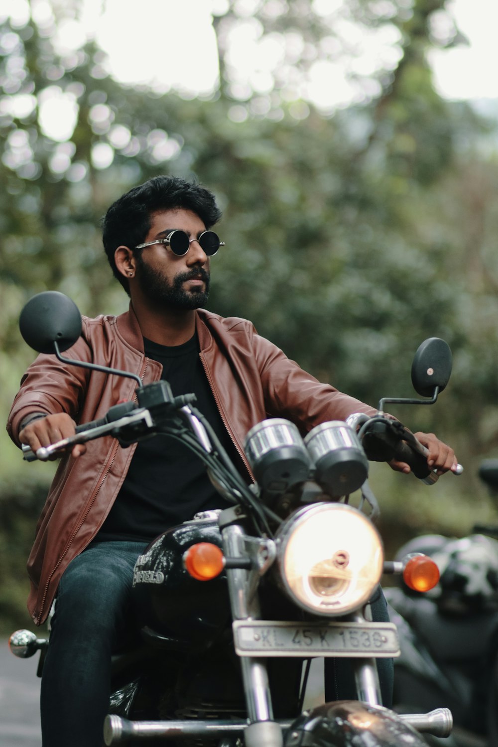 a man wearing sunglasses and riding a motorcycle