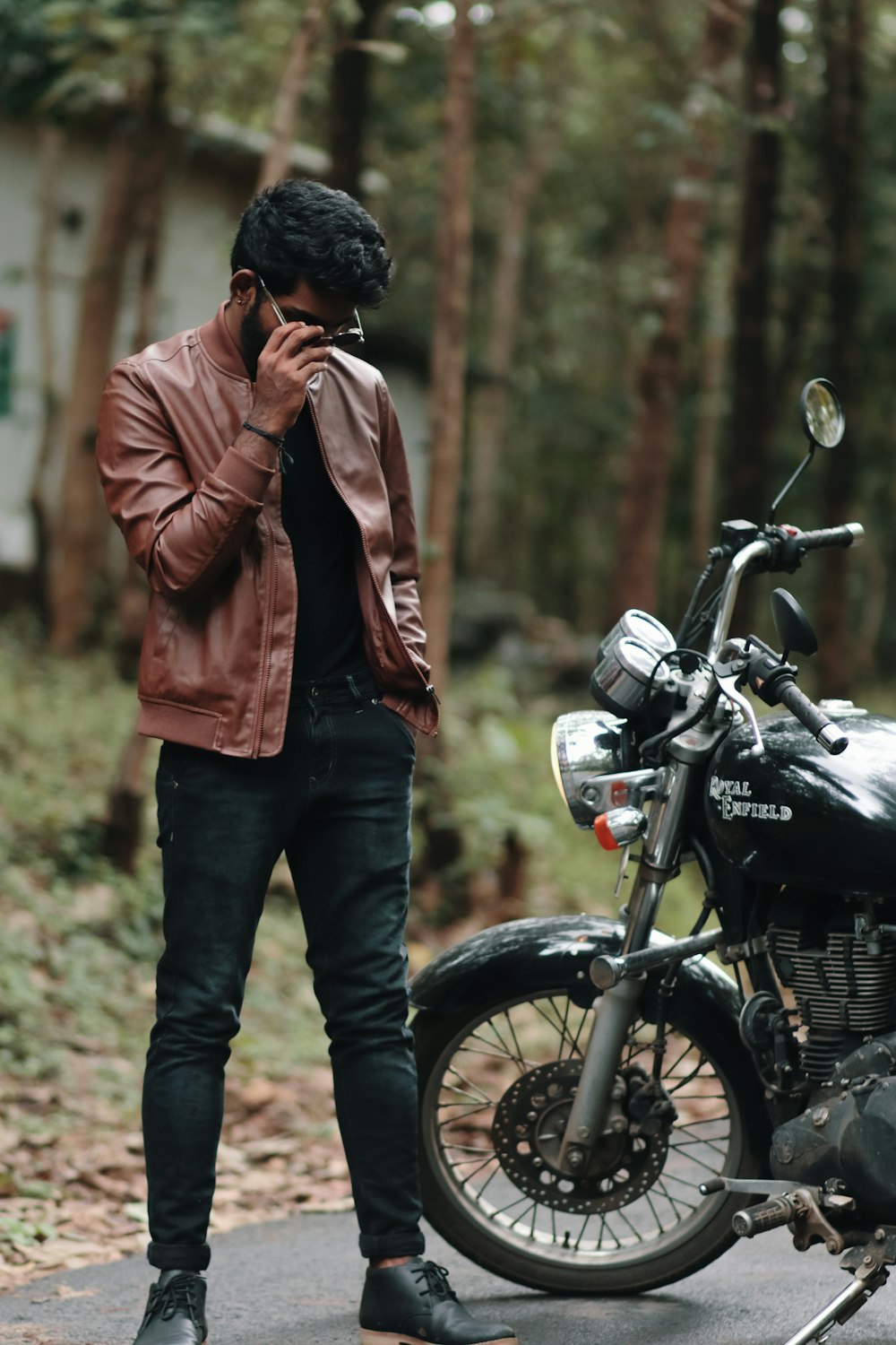 a man standing next to a motorcycle