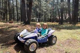 two children on a toy tractor