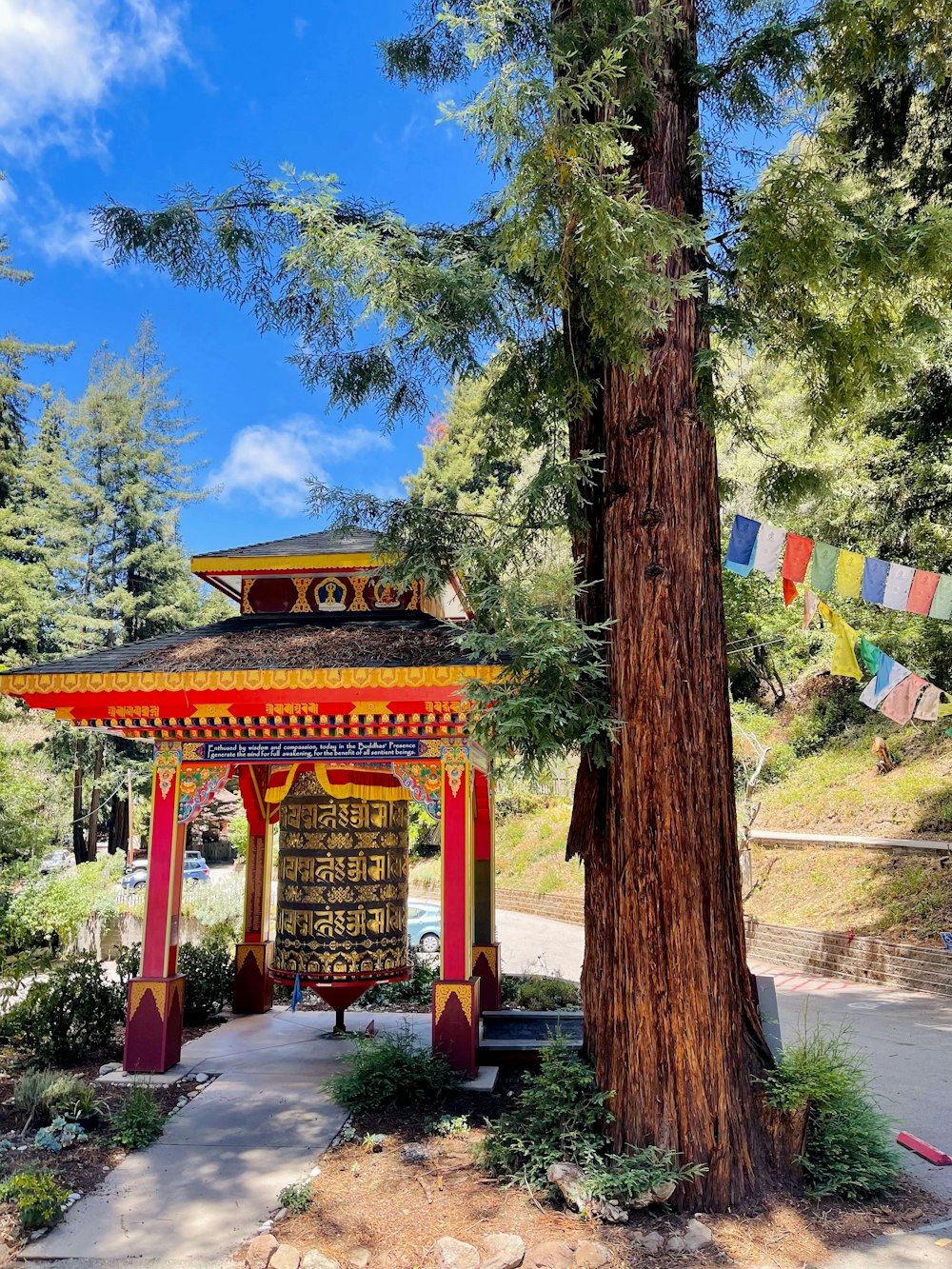 a red pagoda with a tree in front of it