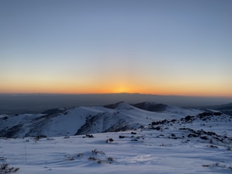 A sunset view over snowy peaks reflecting the calm after a day of coaching and coding.